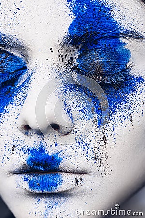 Fashion model girl portrait with colorful powder make up. woman with bright blue makeup and white skin. Abstract fantasy Stock Photo