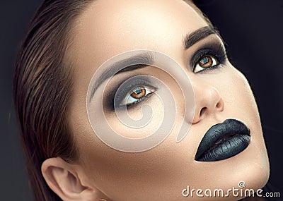 Fashion model girl portrait with trendy gothic black makeup. Young woman with black lipstick, dark smokey eyes Stock Photo