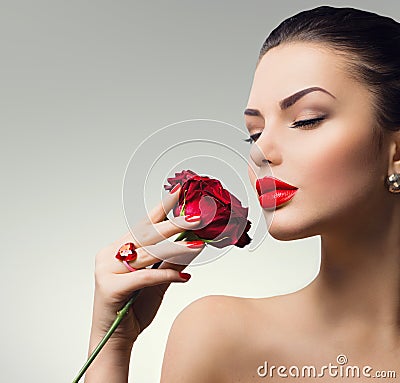 Fashion model girl with red rose in her hand Stock Photo