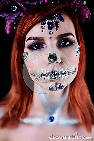 Fashion model with halloween skull makeup with glitter and rhinestones Stock Photo