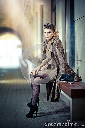 Fashion Model With Long Sexy Legs Sitting On Bench Stock Photo - Image ...