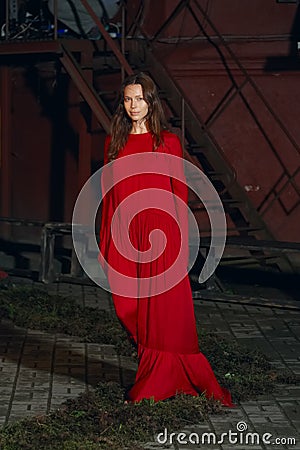 Fashion model in long wide designers dress at night show Stock Photo