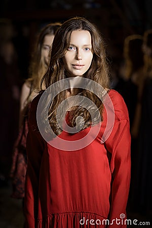 Fashion model in long wide designers dress at night show Stock Photo