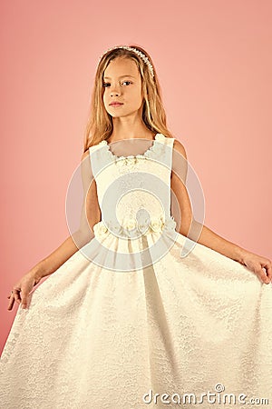 Fashion model on pink background, beauty. Child girl in stylish glamour dress, elegance. Look, hairdresser, makeup Stock Photo