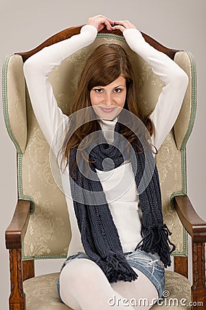 Fashion model posing on antique armchair Stock Photo