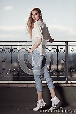 Fashion model. Summer look. Jeans, sneakers, sweater. Stock Photo