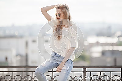 Fashion model. Summer look. Jeans, sweater, sunglasses. Stock Photo