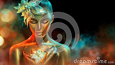 Fashion model woman in colorful bright golden sparkles and neon lights posing with fantasy flower. Portrait of beautiful girl Stock Photo