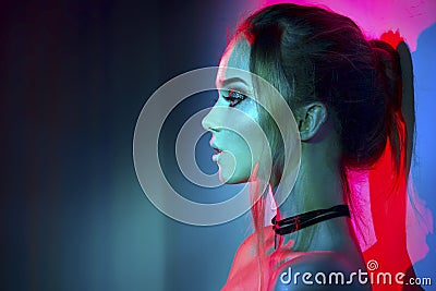 Fashion model woman in colorful bright lights posing Stock Photo