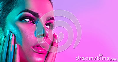 Fashion model woman in colorful bright lights with trendy makeup and manicure Stock Photo