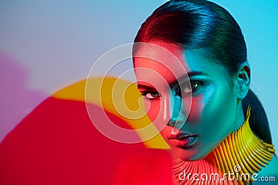 Fashion model woman in colorful bright lights with trendy makeup and manicureFashion model woman in colorful bright lights posing Stock Photo