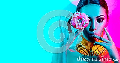 Fashion model woman posing in studio with donut Stock Photo