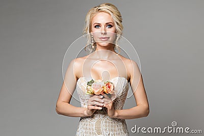 Fashion Models Beauty Portrait with Flowers Bouquet, Beautiful Woman Makeup and Hairstyle, Girl studio shot on gray Stock Photo