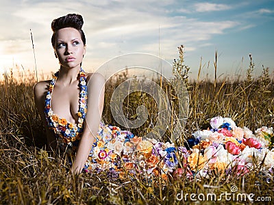 Fashion photo of beautiful lady in dress of flowers Stock Photo