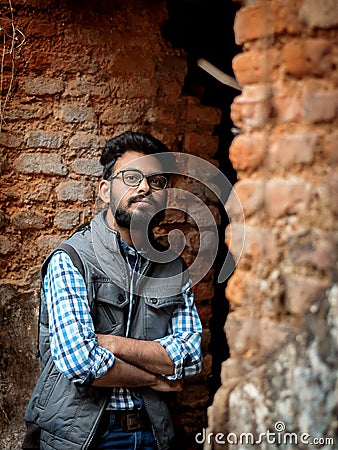 Fashion portrait of Bearded Guy on the front of old buildingTAKI RAJBARI Stock Photo