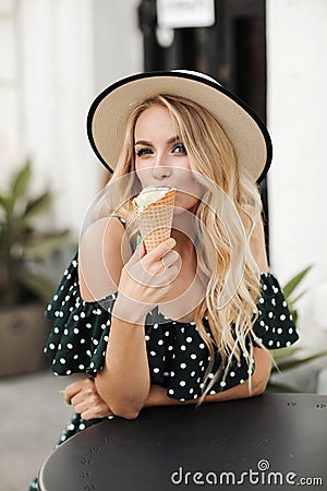 Fashion portrait of a beautiful woman outdoor with ice cream Stock Photo