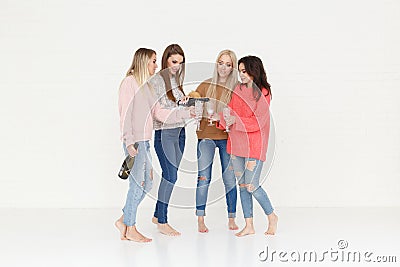 Fashion portrait of four women drinking champagne and having fun Stock Photo