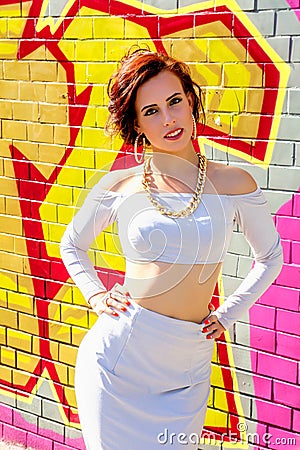 Fashion portrait of brunette swag girl against the background of graffiti Editorial Stock Photo