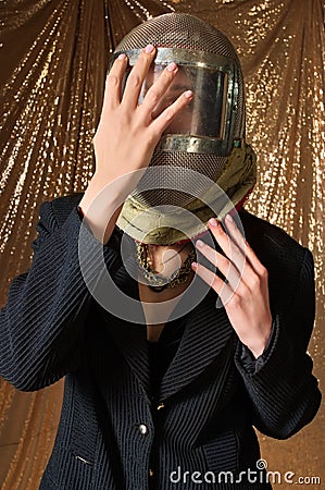 fashion portrait of a woman in a protective mask swordsman. golden background. Stock Photo