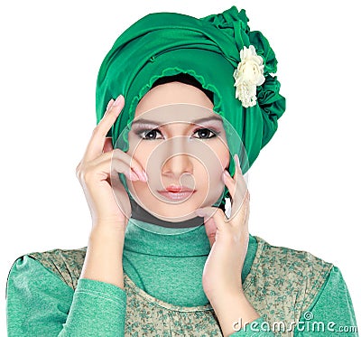 Fashion portrait of young beautiful muslim woman with green cost Stock Photo