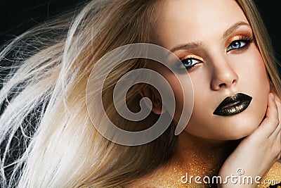 Fashion portrait of young caucasian model with golden sparkles on her neck. Stock Photo