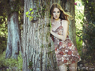 Fashion portrait of young sensual woman in garden Stock Photo