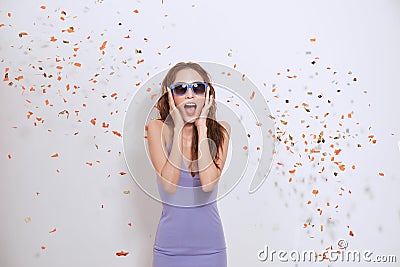 Fashion pretty woman enjoying a orange silver confetti rain Stock Photo