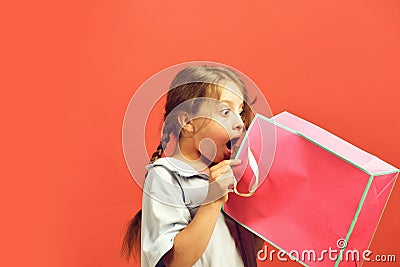 Fashion and shopaholism concept. Girl holds pink shopping bag Stock Photo