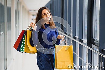 Fashion Shopping Girl Portrait. Beauty Woman with Shopping Bags in Shopping Mall. Shopper. Sales. Shopping Center Stock Photo