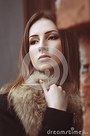 Fashion street portrait of a beautiful woman in fur coat Stock Photo