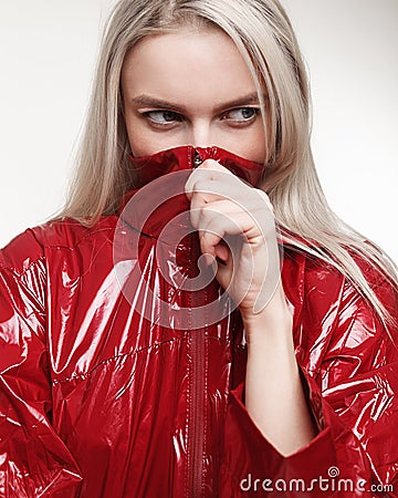 Fashion studio photo of woman in red jacket and painted makeup o Stock Photo