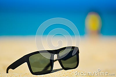 Fashion sunglasses on sea beach. Summer holiday relax background with copy space Stock Photo