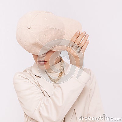 Fashion Urban Model. Stylish Details of everyday outfit. Casual beige aesthetics.Trendy accessories velvet cap, rings and chaine. Stock Photo