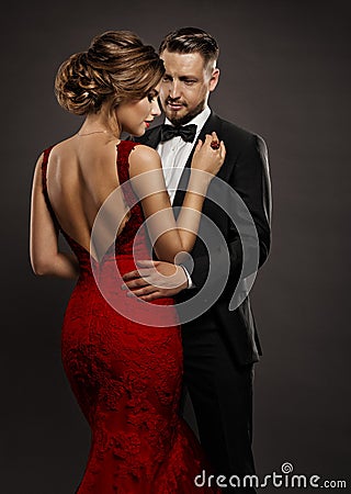 Fashion Wedding Couple in Love. Beauty Woman in Sexy Dress with Naked Back and Handsome Man in Black Suit. Gentlemen and Lady Stock Photo