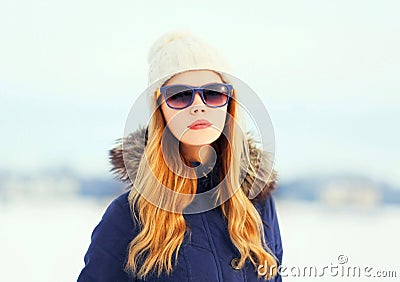 Fashion winter portrait pretty blonde woman wearing a jacket hat sunglasses Stock Photo