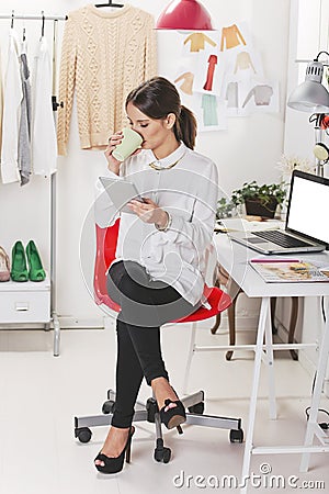 Fashion woman blogger working in a creative workspace with digit Stock Photo