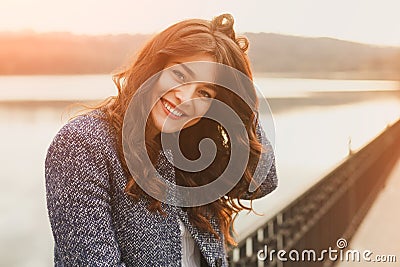 Fashion woman outdoor portrait. Beautiful girl posing on the street in black coat. Photo toned style instagram filters Stock Photo