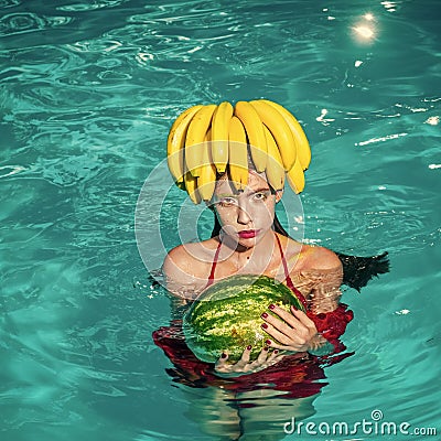 Fashion woman watermelon and banana enjoy in swimming pool. Stock Photo