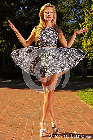 Fashion young woman in park stylized like marionet Stock Photo