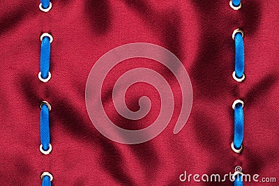 Fashionable beautiful background, blue satin ribbon inserted in red satin fabric Stock Photo
