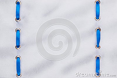 Fashionable beautiful background, blue satin ribbon inserted in white fabric Stock Photo