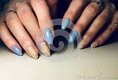 Fashionable blue manicure stylish yellow design drops splatter Stock Photo