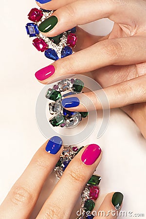 Fashionable colorful short nail art design on female hand Stock Photo