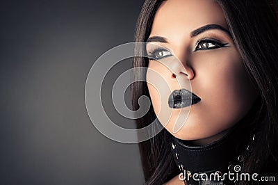 Fashionable dark make-up submissive brunette woman Stock Photo