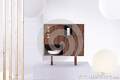 Fashionable dark wooden commode in bright interior Stock Photo