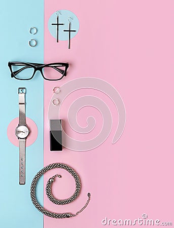 Fashionable female accessories watch, glasses, earrings, perfume, rings and necklace with copy space Stock Photo