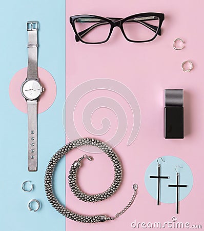 Fashionable female accessories watch, glasses, earrings, perfume, rings and necklace with copy space Stock Photo