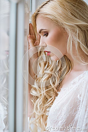 Fashionable female portrait of cute lady in white robe indoors Stock Photo