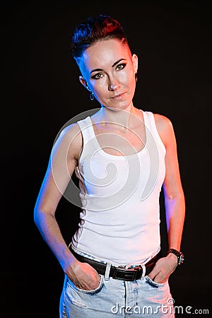 Fashionable girl with stylish haircut posing on black background with trendy Stock Photo