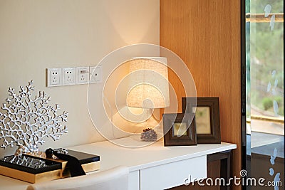 Fashionable glass lamp on desk Stock Photo